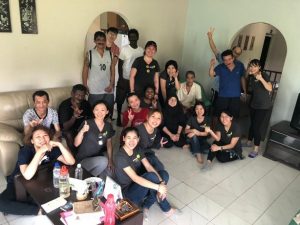 Volunteers smile for group photo with residents