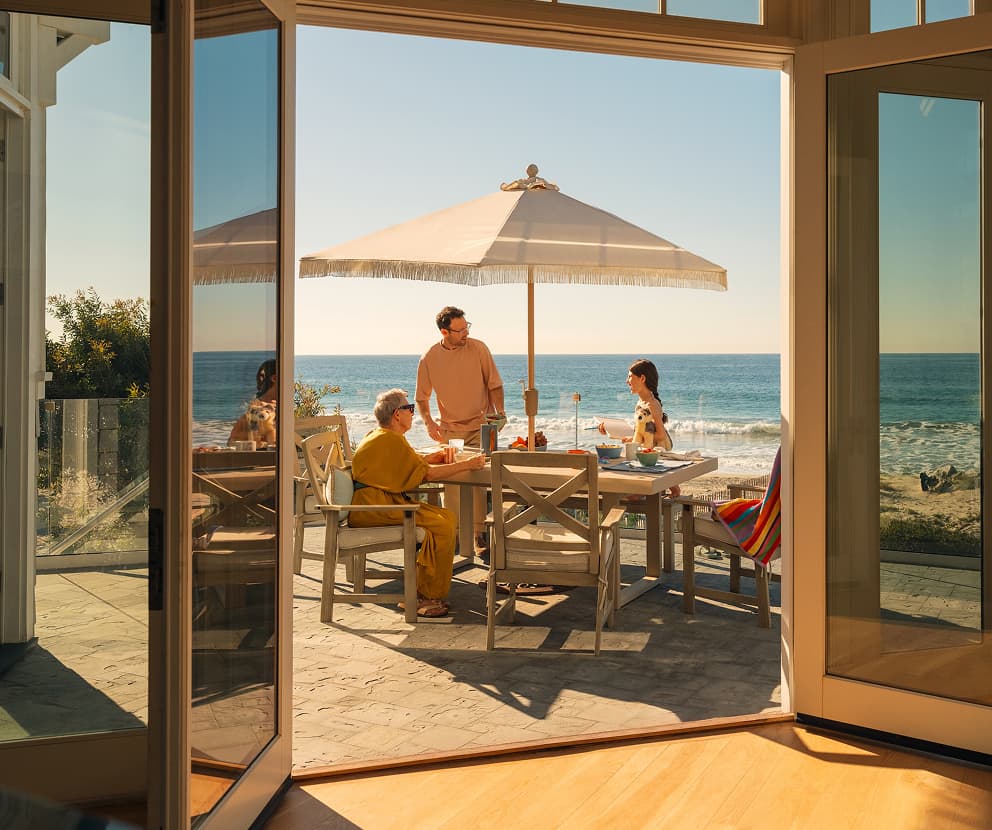 Travelers dining by the ocean