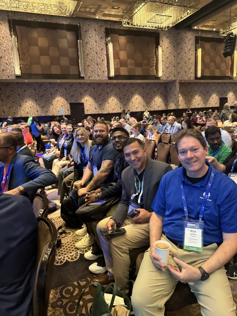 Expedians smiling and sitting in a row awaiting a session to start