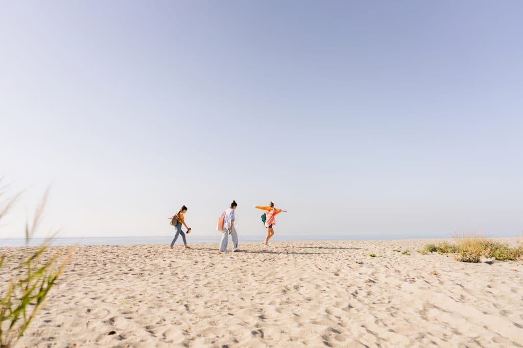 Expedia Group colleagues walking on a beach