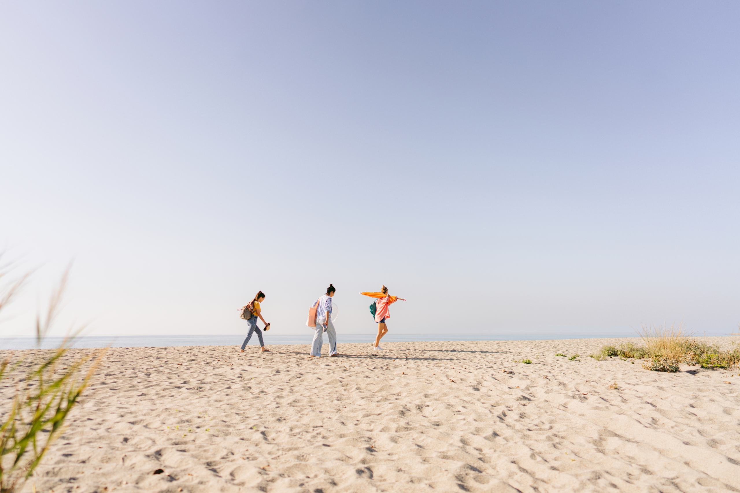 Expedia Group colleagues walking on a beach